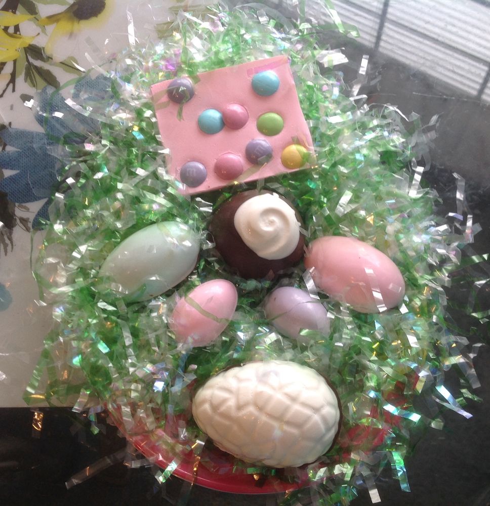 Homemade chocolate candy eggs in a spring basket