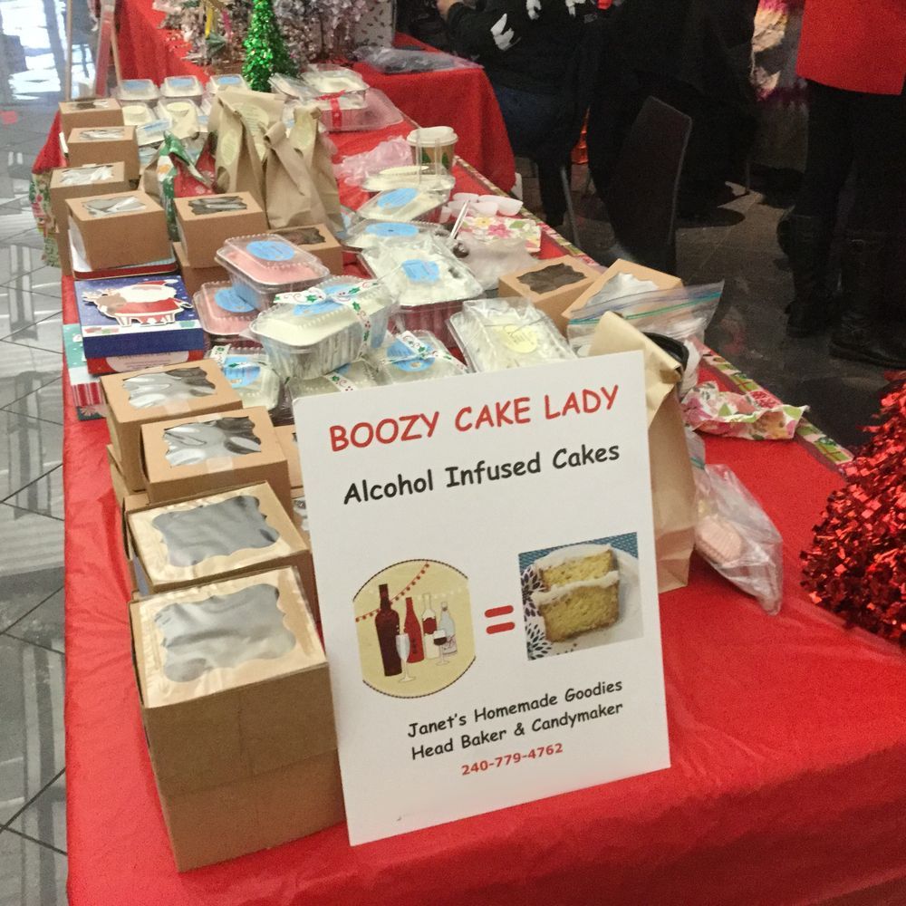 The Boozy Cake Lady sign on Janet's red festival table