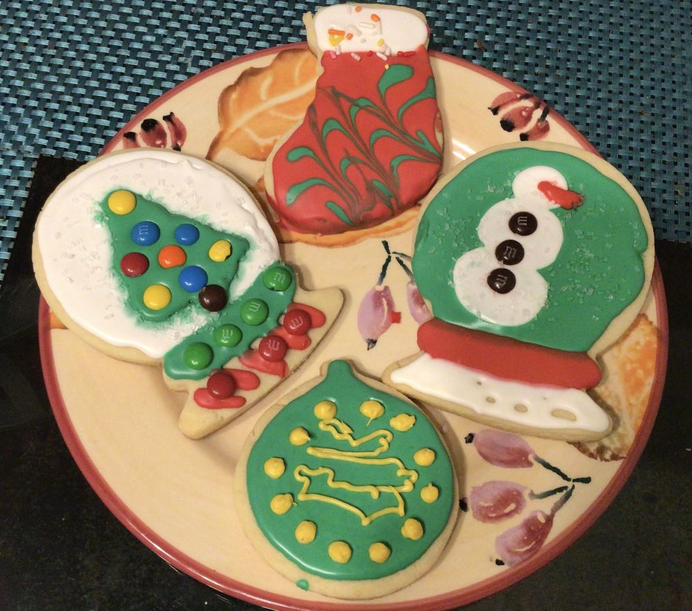 Hand-decorated Christmas cookies: a tree, a snowman and an ornament