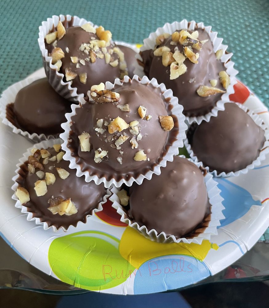 Chocolate rum balls topped with chopped nuts